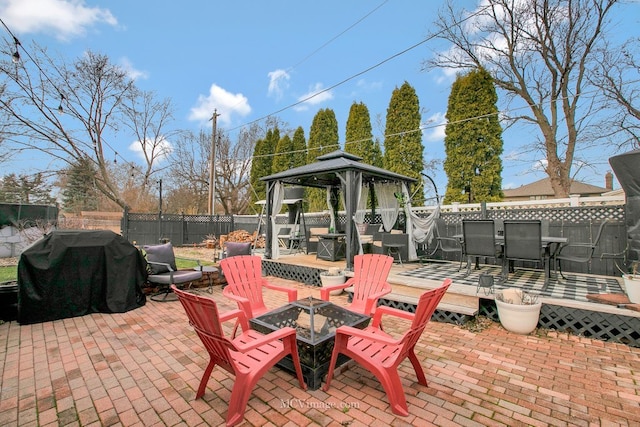 view of patio with a fire pit, area for grilling, and a gazebo