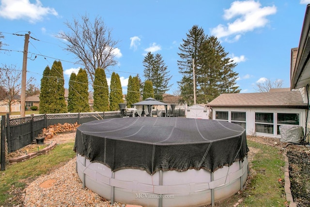 view of yard featuring a gazebo and a covered pool