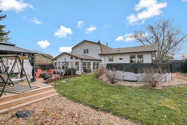 back of house with a lawn, a sunroom, a swimming pool side deck, central AC, and a gazebo