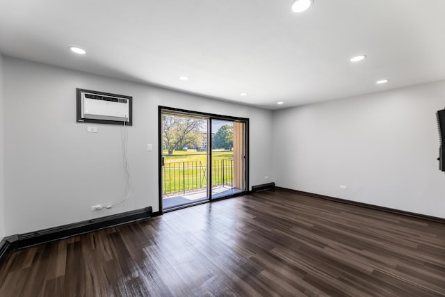 empty room with a wall mounted AC and dark wood-type flooring