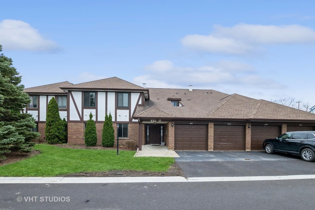 view of front of property with a garage and a front yard