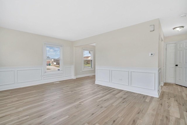 empty room with light hardwood / wood-style flooring