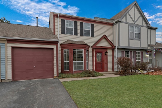 view of front facade with a front yard and a garage