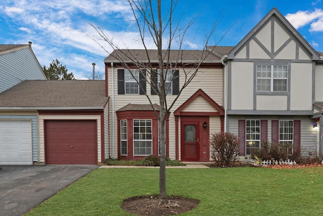 view of front of house with a garage and a front lawn