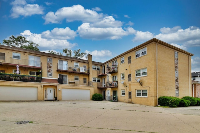 3207 N Pontiac Ave Unit 2S, Chicago, IL 60634 - view of apartment building / complex with concrete driveway and an attached garage
