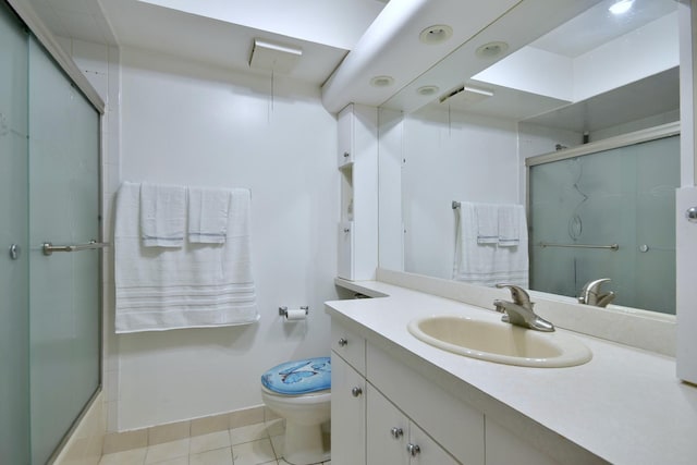 full bathroom featuring tile patterned floors, vanity, toilet, and enclosed tub / shower combo