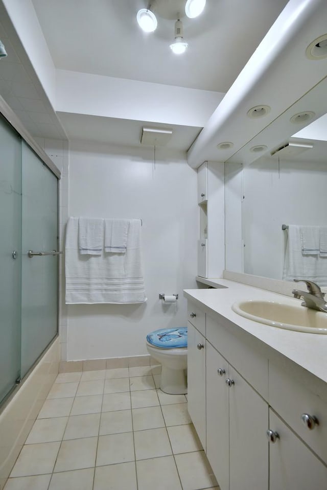 3207 N Pontiac Ave Unit 2S, Chicago, IL 60634 - bathroom with vanity, tile patterned flooring, and bath / shower combo with glass door