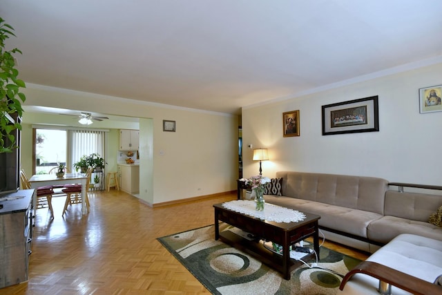 living room with ceiling fan, ornamental molding, and light parquet floors