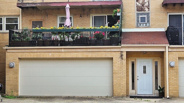 doorway to property with a garage