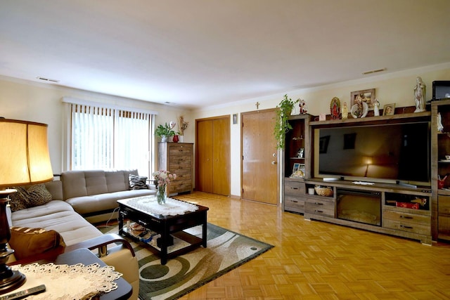 living room featuring ornamental molding and light parquet flooring