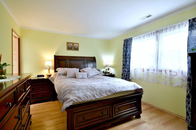 3207 N Pontiac Ave Unit 2S, Chicago, IL 60634 - bedroom with light wood-type flooring and crown molding