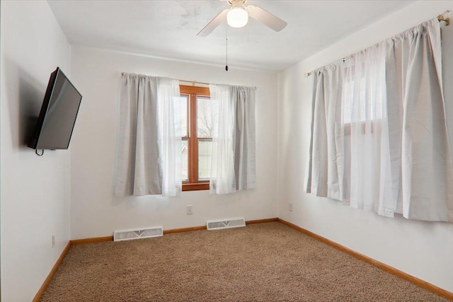 carpeted spare room with ceiling fan