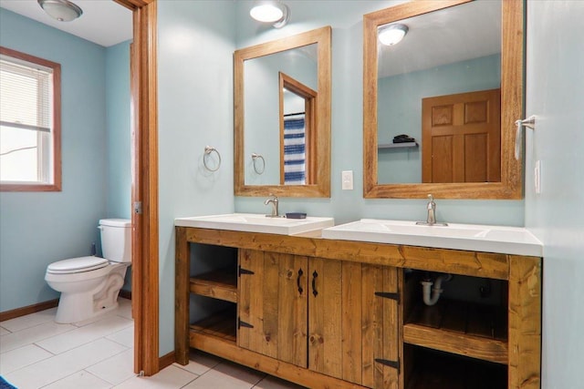 bathroom featuring tile patterned floors, vanity, and toilet