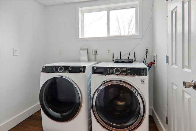 washroom featuring washing machine and clothes dryer and dark hardwood / wood-style flooring