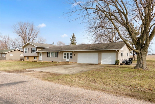 view of front of house with a garage and a front lawn