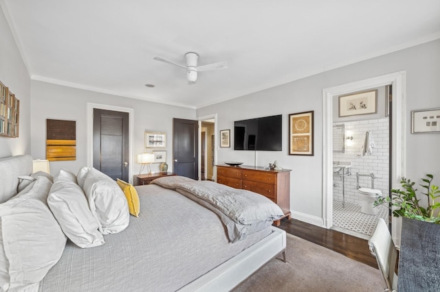 bedroom featuring dark wood-type flooring, ensuite bathroom, ornamental molding, and ceiling fan