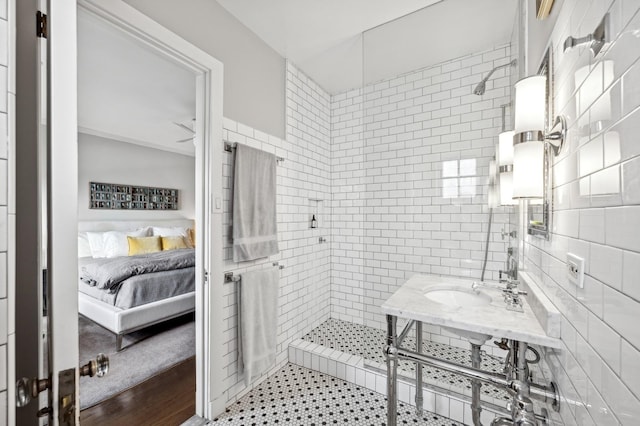 full bathroom with ensuite bathroom, tile walls, a stall shower, and decorative backsplash