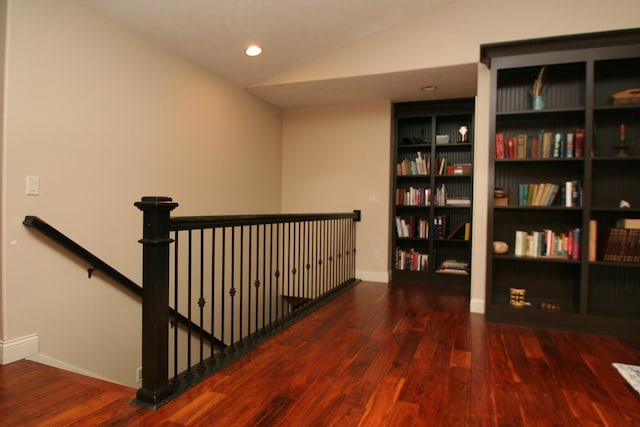 hall featuring dark hardwood / wood-style flooring and lofted ceiling