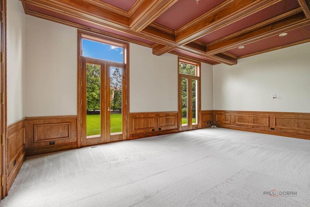 unfurnished room featuring light colored carpet, coffered ceiling, crown molding, and beamed ceiling