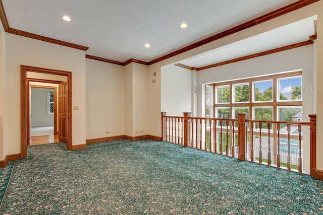 carpeted spare room featuring ornamental molding