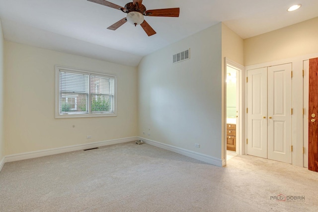 spare room featuring light carpet and ceiling fan