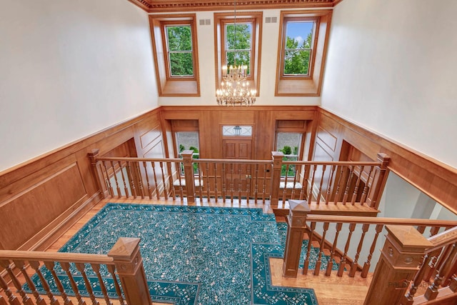 stairs featuring an inviting chandelier