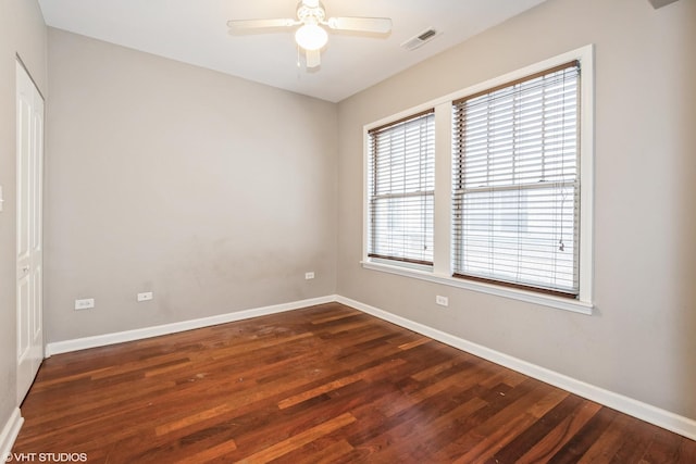 spare room with ceiling fan and dark hardwood / wood-style floors