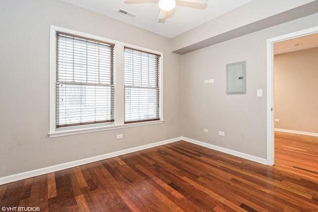 unfurnished room with wood-type flooring, electric panel, a healthy amount of sunlight, and ceiling fan