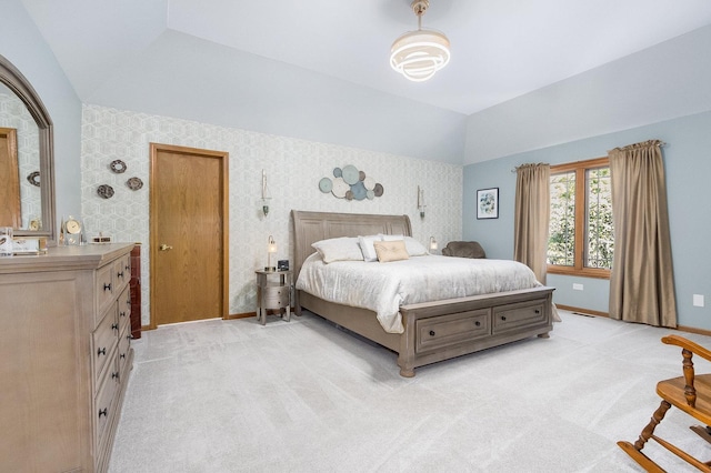 carpeted bedroom featuring sink and vaulted ceiling