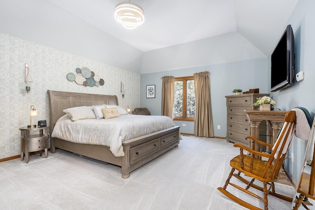 bedroom with lofted ceiling and light carpet