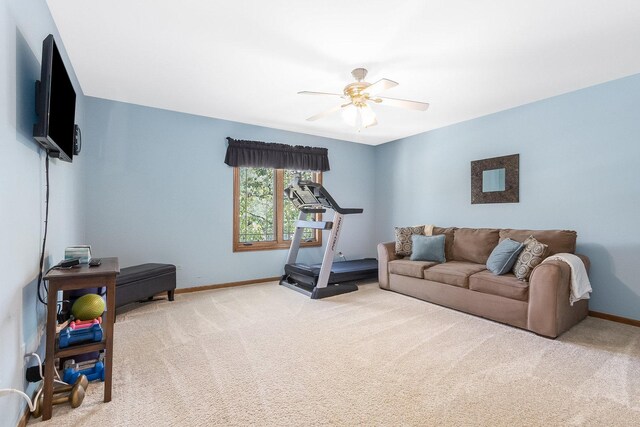 exercise area featuring carpet floors and ceiling fan