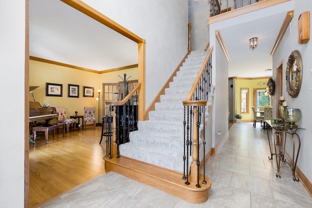 entryway with crown molding and light hardwood / wood-style flooring