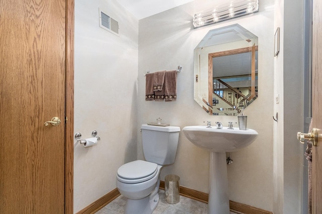 bathroom with tile patterned flooring and toilet