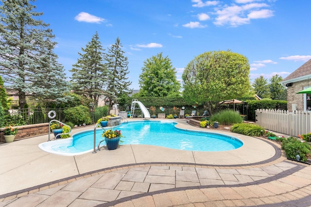 view of swimming pool featuring a patio and a water slide