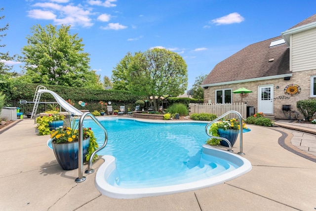 view of swimming pool featuring a patio and a water slide