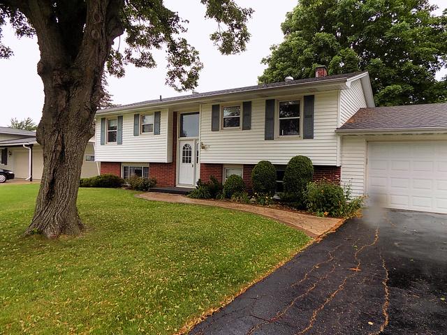 bi-level home with a front yard and a garage