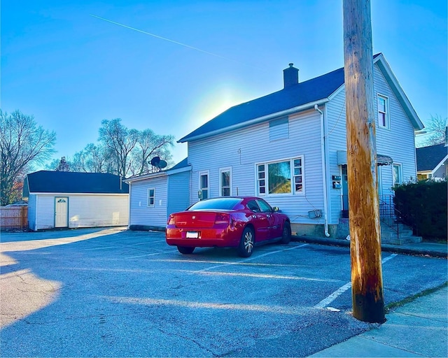 view of front of home featuring a storage unit