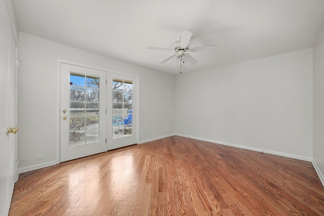 spare room with ceiling fan and wood-type flooring