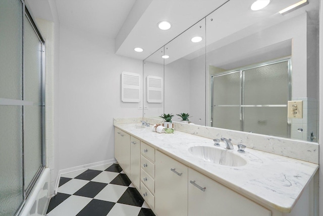 bathroom featuring vanity and combined bath / shower with glass door