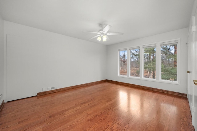 spare room with hardwood / wood-style floors and ceiling fan