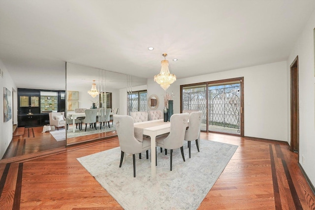 dining room featuring wood-type flooring and a notable chandelier