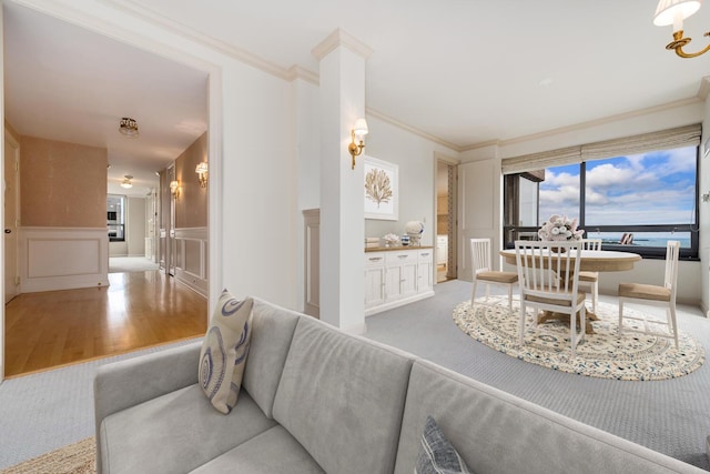 living room with ornamental molding and light hardwood / wood-style floors