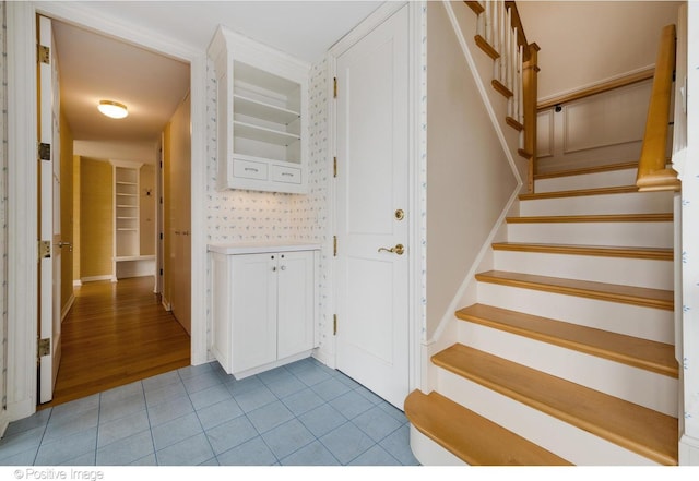 stairs featuring tile patterned floors