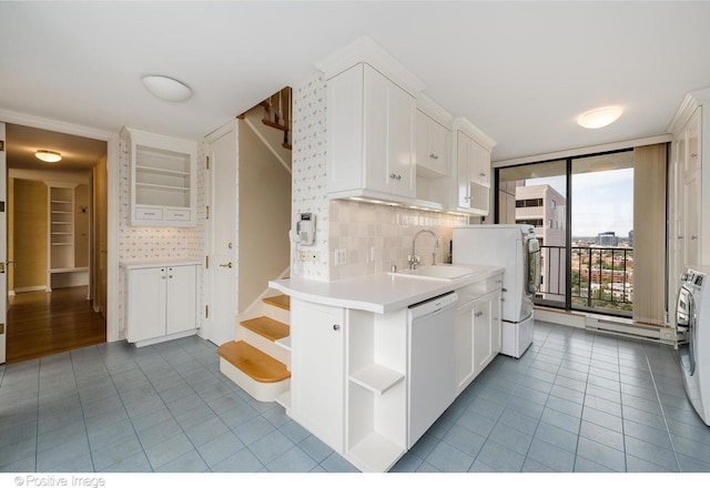 kitchen featuring floor to ceiling windows, dishwasher, tasteful backsplash, white cabinets, and sink