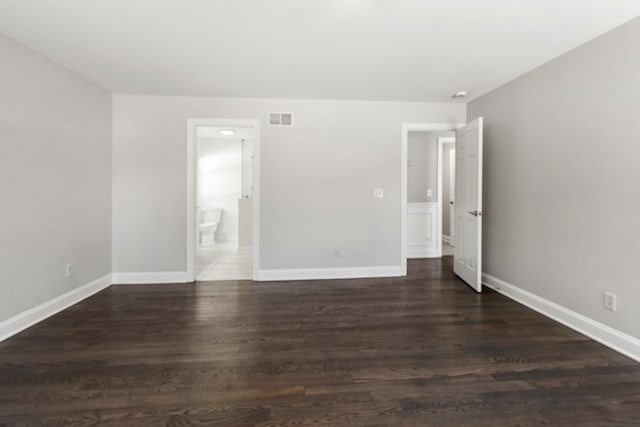 spare room with dark hardwood / wood-style flooring