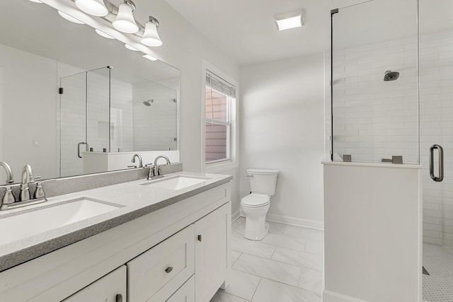 bathroom featuring toilet, a shower with shower door, and vanity