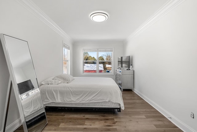 bedroom featuring dark wood-type flooring and crown molding