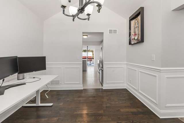 office space featuring a notable chandelier, vaulted ceiling, and dark hardwood / wood-style flooring