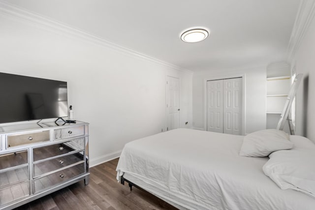 bedroom with dark hardwood / wood-style flooring, a closet, and ornamental molding