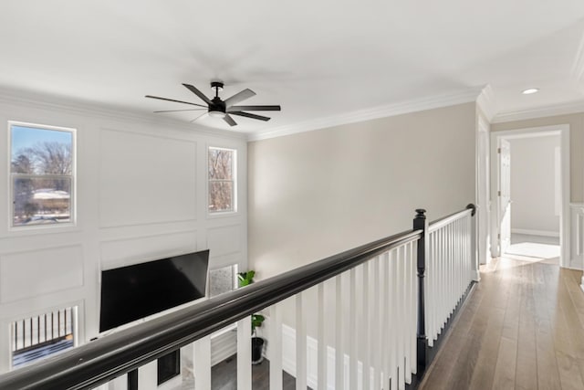 corridor with hardwood / wood-style flooring and ornamental molding